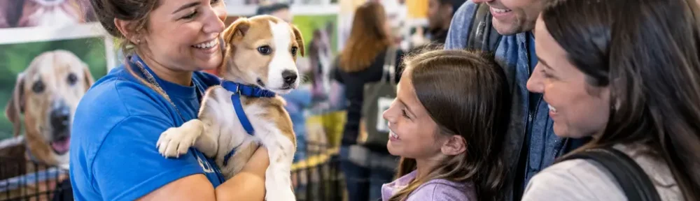 Families meet adoptable pets at the Pittsburgh Pet Expo with rescue volunteers nearby